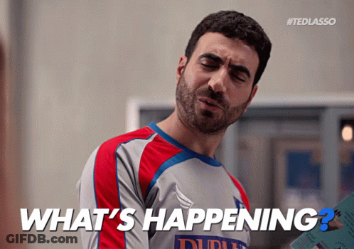 A Man Wearing A Shirt That Says What 'S Happening On It GIF