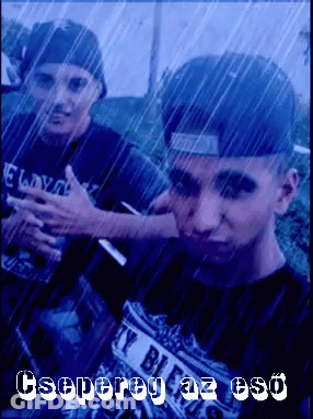 A Man Wearing A Shirt That Says ' Y Bill ' On It Is Standing In The Rain GIF