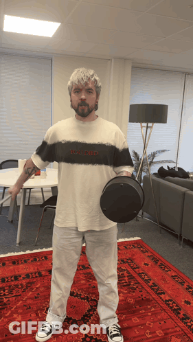 A Man Wearing A Shirt That Says You Died Holds A Black Object GIF