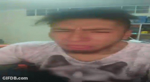 A Man Wearing A Shirt With A Cat On It Is Making A Funny Face GIF