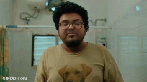 A Man Wearing A Shirt With A Dog On It Is Washing His Hands GIF