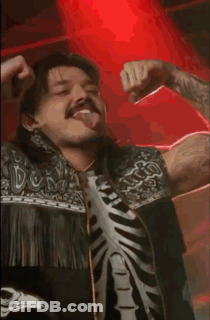 A Man Wearing A Skeleton Shirt Is Dancing In A Dark Room GIF