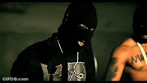 A Man Wearing A Ski Mask And A Shirt With The Letter W On It GIF