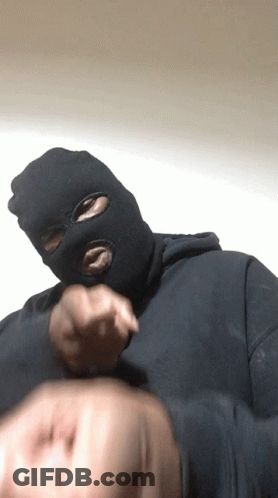 A Man Wearing A Ski Mask Is Pointing His Finger GIF