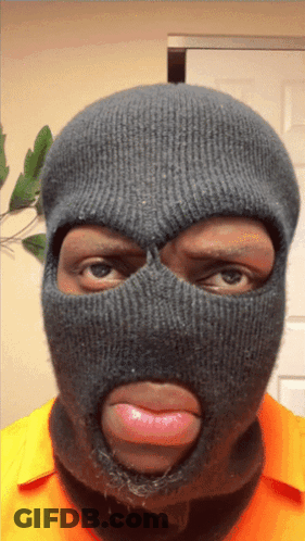 A Man Wearing A Ski Mask With His Tongue Out GIF