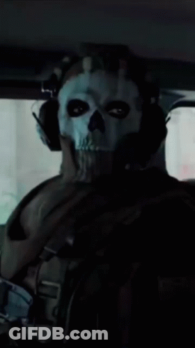A Man Wearing A Skull Mask And Headphones Is Sitting In A Car GIF