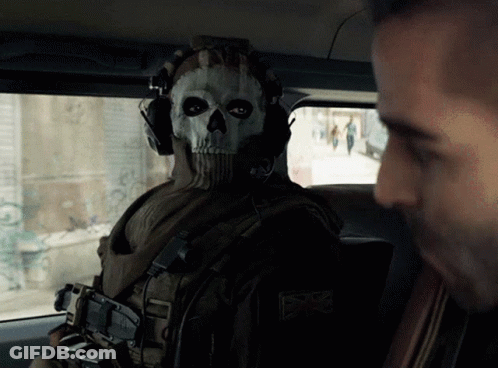 A Man Wearing A Skull Mask Looks At Another Man In A Car GIF