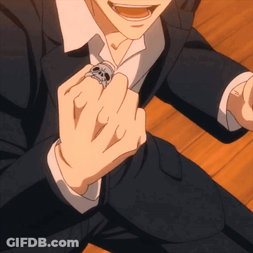 A Man Wearing A Skull Ring On His Finger GIF