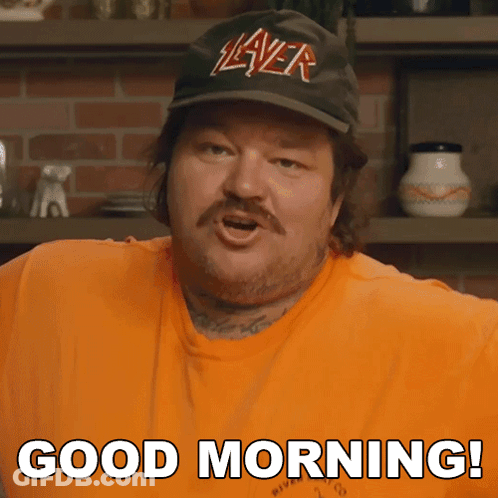 A Man Wearing A Slayer Hat And An Orange Shirt Says Good Morning GIF