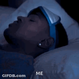 A Man Wearing A Sleep Mask Is Laying In Bed At Night And Says Me . GIF