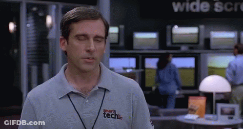 A Man Wearing A Smart Tech Shirt Stands In Front Of A Wide Screen Tv GIF