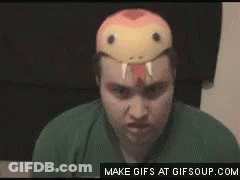 A Man Wearing A Snake Mask On His Head Is Making A Funny Face . GIF