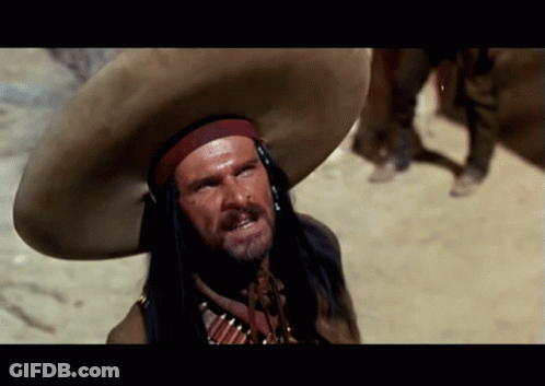 A Man Wearing A Sombrero And A Native American Costume GIF