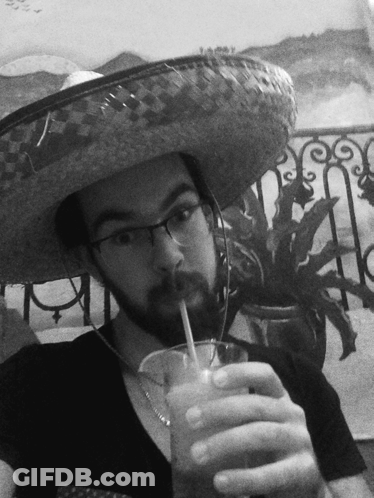A Man Wearing A Sombrero And Glasses Is Drinking A Drink Through A Straw GIF