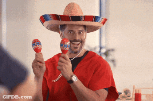 A Man Wearing A Sombrero And Holding Maracas In His Hands GIF