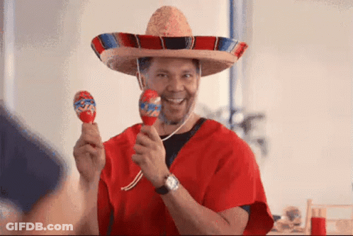 A Man Wearing A Sombrero And Holding Maracas In His Hands GIF