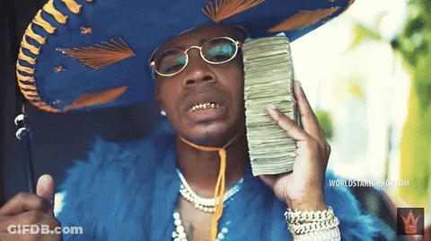 A Man Wearing A Sombrero Holds A Stack Of Money GIF
