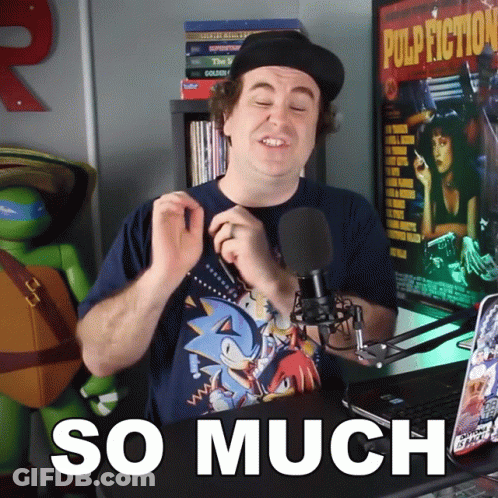 A Man Wearing A Sonic T-Shirt Stands In Front Of A Microphone And Says So Much GIF