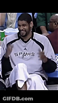 A Man Wearing A Spurs Jersey Sits In A Stadium GIF