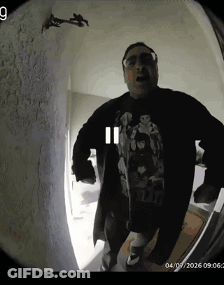 A Man Wearing A Star Wars Shirt Is Standing In A Room GIF