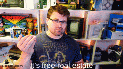 A Man Wearing A Star Wars T-Shirt Is Holding Something In His Hand GIF