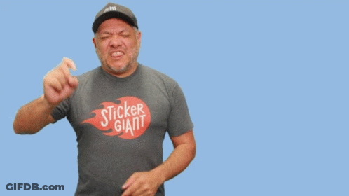 A Man Wearing A Sticker Giant Shirt Stands In Front Of A Blue Background GIF