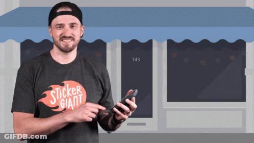 A Man Wearing A Sticker Giant T-Shirt Holds A Cell Phone GIF
