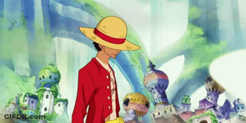 A Man Wearing A Straw Hat And A Red Jacket Is Standing In Front Of A Building . GIF