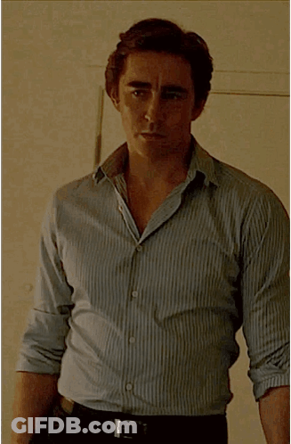 A Man Wearing A Striped Shirt And Black Belt GIF