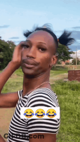 A Man Wearing A Striped Shirt Is Making A Funny Face With Three Smiley Faces . GIF