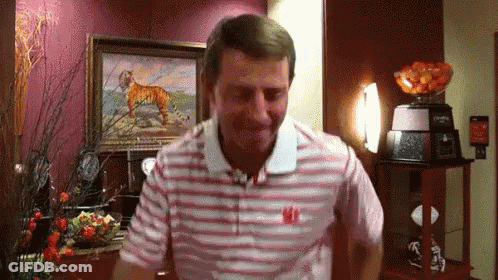A Man Wearing A Striped Shirt With The Letter W On The Front GIF