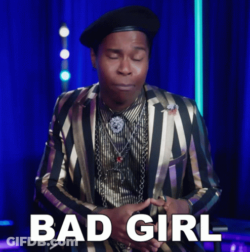 A Man Wearing A Striped Suit And A Black Hat Says Bad Girl GIF
