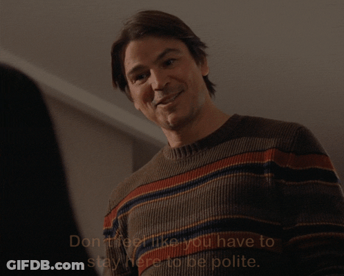 A Man Wearing A Striped Sweater Says " Don 'T Feel Like You Have To Stay Here To Be Polite " GIF