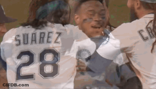 A Man Wearing A Suarez 28 Jersey Is Hugging Another Man GIF