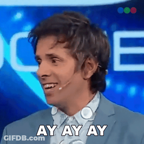 A Man Wearing A Suit And A Microphone Is Smiling And Saying Ay Ay Ay GIF