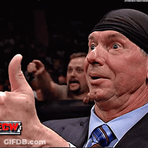A Man Wearing A Suit And Tie Is Giving A Thumbs Up GIF