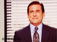 A Man Wearing A Suit And Tie Is Smiling In Front Of A Window GIF