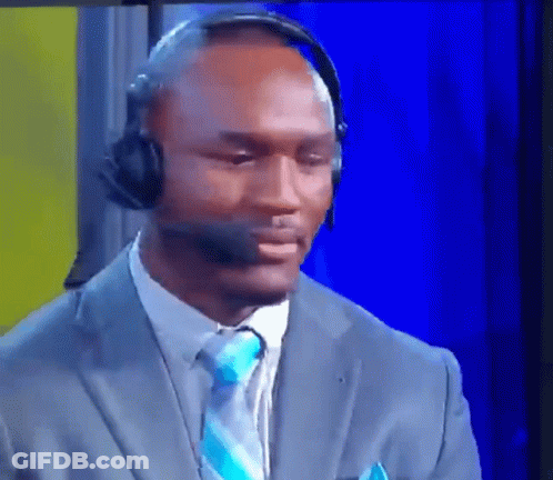 A Man Wearing A Suit And Tie Is Wearing A Headset GIF