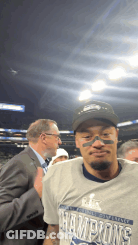 A Man Wearing A Super Bowl Champions T-Shirt GIF