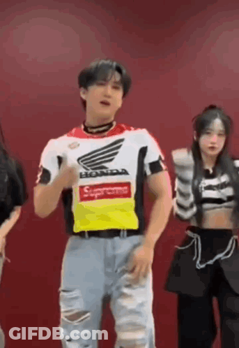 A Man Wearing A Supreme Shirt Is Dancing With A Group Of People . GIF