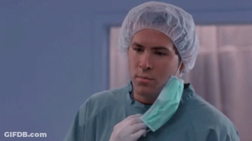 A Man Wearing A Surgical Gown And A Mask Says But Why GIF