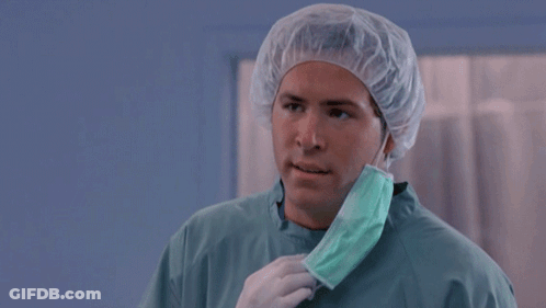 A Man Wearing A Surgical Gown And A Mask Says But Why GIF