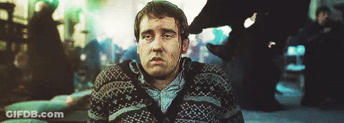 A Man Wearing A Sweater Is Sitting On The Floor With His Eyes Closed . GIF