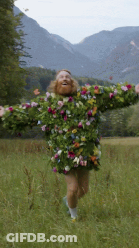 A Man Wearing A Sweater Made Of Flowers And Leaves GIF
