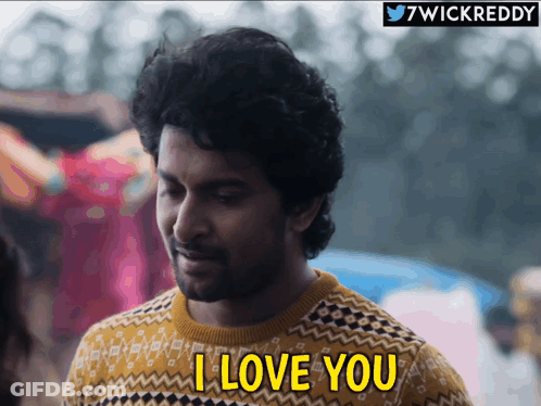 A Man Wearing A Sweater Says I Love You GIF