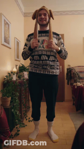 A Man Wearing A Sweater That Says " All " On The Front GIF