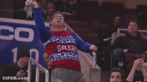 A Man Wearing A Sweater That Says Flyers Is Dancing In The Stands GIF