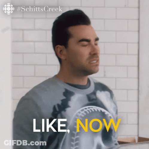 A Man Wearing A Sweater That Says " Like Now " GIF