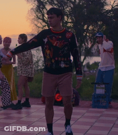 A Man Wearing A Sweater With A Superhero On It GIF