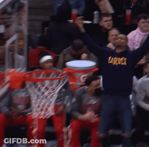 A Man Wearing A Sweatshirt That Says Specs Is Raising His Arms In The Air GIF